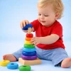 baby playing with a wooden rainbow ring stacking toy educational developmental play by ToyRoots