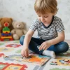Child playing with dinosaur educational toy in Pakistan