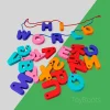 Detailed view of smooth, non-toxic painted wooden alphabet blocks with threading holes, showing sustainable wood grain.