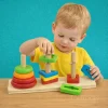 Child playing with a colorful rainbow three-column stacking tower educational toy